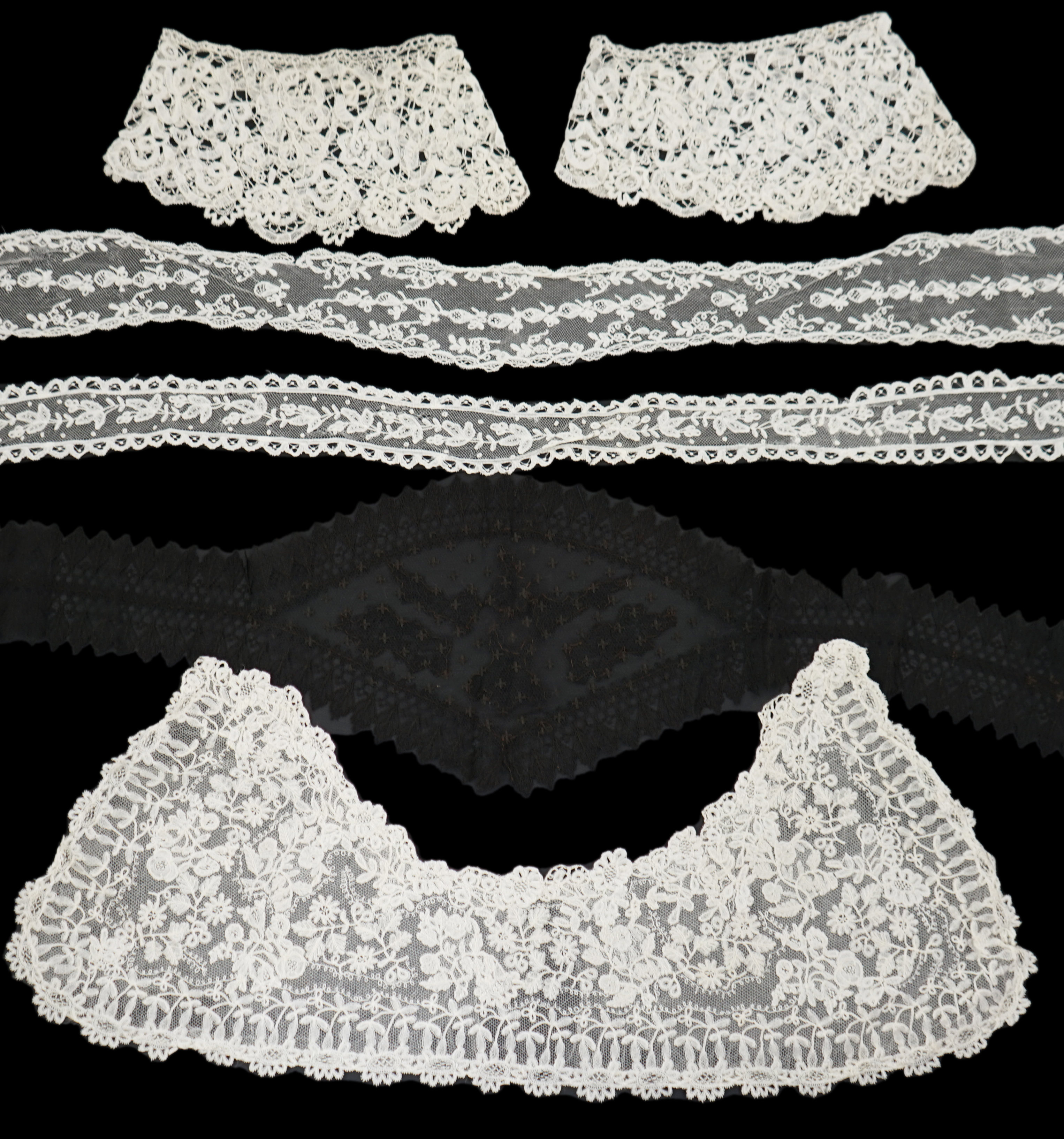 A small collection of late 19th century laces including a cream Brussels bobbin lace collar appliquéd on to net and two similar Brussels bobbin lace lappets, a pair of cream Honiton bobbin lace cuffs and a black lace fal